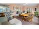 Sunroom featuring neutral peach walls, carpeted floors, lots of windows, and seating area at 4461 Baroda Ave, North Port, FL 34287