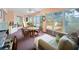 Bright sunroom featuring neutral peach walls, carpeted floors and multiple windows at 4461 Baroda Ave, North Port, FL 34287