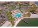 Aerial view of community featuring a pool, tennis court, parking, and lake access, offering a comprehensive recreational lifestyle at 5020 Brittany S Dr # 324, St Petersburg, FL 33715