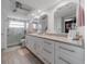 Well-appointed bathroom with dual sinks, granite countertops, and a glass-enclosed shower at 5020 Brittany S Dr # 324, St Petersburg, FL 33715