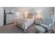 Comfortable bedroom features a large bed, soft lighting and a barn door to the en suite at 5020 Brittany S Dr # 324, St Petersburg, FL 33715