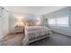 Comfortable bedroom features a large bed, soft lighting and a barn door to the en suite at 5020 Brittany S Dr # 324, St Petersburg, FL 33715