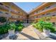 Well-maintained courtyard of the building with lush tropical landscaping and walkway to unit at 5020 Brittany S Dr # 324, St Petersburg, FL 33715
