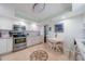 Bright kitchen features stainless steel appliances, white cabinets and a cozy dining table at 5020 Brittany S Dr # 324, St Petersburg, FL 33715