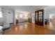 Inviting living room with hardwood floors, neutral decor and a large display cabinet at 5020 Brittany S Dr # 324, St Petersburg, FL 33715