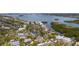 Areal neighborhood view of waterfront homes nestled amongst mature trees lining winding residential streets at 5239 Siesta Cove Dr, Sarasota, FL 34242