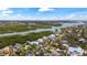 Picturesque aerial view showcases waterfront homes along a river, blending luxury living and natural beauty at 5239 Siesta Cove Dr, Sarasota, FL 34242