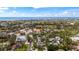 An elevated view features a neighborhood near the shore with blue skies and a vibrant cityscape backdrop at 5239 Siesta Cove Dr, Sarasota, FL 34242