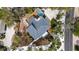 Aerial view of home with a new roof, pool, and deck surrounded by trees and lush landscaping at 5239 Siesta Cove Dr, Sarasota, FL 34242