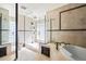 Elegant bathroom featuring a glass shower, a soaking tub, and decorative tile accents at 5239 Siesta Cove Dr, Sarasota, FL 34242