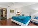 Inviting bedroom with hardwood floors, cozy seating area, and ample closet space at 5239 Siesta Cove Dr, Sarasota, FL 34242