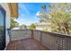 A wooden deck with lattice railings showcases the backyard view on a sunny day at 5239 Siesta Cove Dr, Sarasota, FL 34242