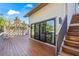 An elevated wooden deck features a pergola overlooking the pool and sliding glass doors to the home at 5239 Siesta Cove Dr, Sarasota, FL 34242
