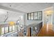 Hallway with custom ceiling, railing, and lighting overlooking the living room at 5239 Siesta Cove Dr, Sarasota, FL 34242