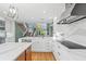 Elegant kitchen with custom cabinets, modern appliances, marble countertops, and an open floor plan at 5239 Siesta Cove Dr, Sarasota, FL 34242
