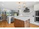 Spacious kitchen boasting marble countertops, custom cabinets, stainless steel appliances, and hardwood floors at 5239 Siesta Cove Dr, Sarasota, FL 34242