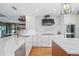 Contemporary kitchen with white marble countertops, custom cabinets, modern appliances, and a stylish backsplash at 5239 Siesta Cove Dr, Sarasota, FL 34242