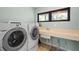 Efficient laundry room with modern appliances, sink, and ample counter space at 5239 Siesta Cove Dr, Sarasota, FL 34242