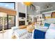 Bright living room with high ceilings, fireplace, and a view of the outdoor pool at 5239 Siesta Cove Dr, Sarasota, FL 34242
