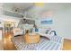 Spacious living area with a large painting and stairs leading to the second floor at 5239 Siesta Cove Dr, Sarasota, FL 34242