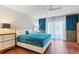 Serene main bedroom with hardwood floors, luxurious curtains, and ample natural light at 5239 Siesta Cove Dr, Sarasota, FL 34242