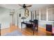 Bright office featuring wooden floors, a stained-glass lamp, and natural light from a window at 5239 Siesta Cove Dr, Sarasota, FL 34242