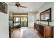 Office space showcasing wooden floors, natural light, large desk, and an area rug at 5239 Siesta Cove Dr, Sarasota, FL 34242
