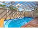 Inviting in-ground pool surrounded by a wooden deck and privacy fence at 5239 Siesta Cove Dr, Sarasota, FL 34242