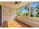 A screened porch with a ceiling fan and views of lush greenery offers a relaxing outdoor space at 5239 Siesta Cove Dr, Sarasota, FL 34242