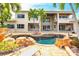 Spacious backyard with a pool, lanai, and lush landscaping, ideal for outdoor entertaining at 7440 Riverside Dr, Punta Gorda, FL 33982