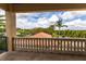 Balcony view showcasing lush tropical foliage and beautiful river view against a partly cloudy, blue sky at 7440 Riverside Dr, Punta Gorda, FL 33982