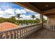 Balcony view showcasing lush tropical foliage and beautiful river view against a partly cloudy, blue sky at 7440 Riverside Dr, Punta Gorda, FL 33982