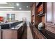 The bar in the basement has a black countertop with dark wood cabinets and a sink at 7440 Riverside Dr, Punta Gorda, FL 33982
