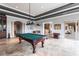 Basement with a pool table, bar area, and access to the outdoor patio, great for entertaining at 7440 Riverside Dr, Punta Gorda, FL 33982