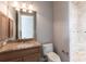 Well lit bathroom with granite counters and tiled shower at 7440 Riverside Dr, Punta Gorda, FL 33982