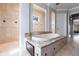 Elegant bathroom with marble tile, soaking tub, separate shower, and updated fixtures at 7440 Riverside Dr, Punta Gorda, FL 33982