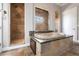 Luxurious bathroom features a standalone soaking tub, walk-in shower, and decorative tile at 7440 Riverside Dr, Punta Gorda, FL 33982