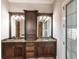Bathroom with double sink vanity, natural stone countertops, and stylish sconce lighting at 7440 Riverside Dr, Punta Gorda, FL 33982