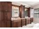 Elegant bathroom with marble tile, double sink, separate shower, and lots of storage at 7440 Riverside Dr, Punta Gorda, FL 33982