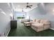 Spacious bedroom with carpet flooring, ceiling fans, a large window with a view and a comfortable seating area at 7440 Riverside Dr, Punta Gorda, FL 33982