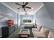Spacious bedroom with carpet flooring, ceiling fans, a large window with a view and a comfortable seating area at 7440 Riverside Dr, Punta Gorda, FL 33982
