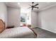 Bright bedroom with a cozy window nook, plush carpet, and a comfortable bed with natural wood furnishings at 7440 Riverside Dr, Punta Gorda, FL 33982