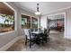 Dining room featuring lots of sunlight, modern table and chairs, and an adjacent living area at 7440 Riverside Dr, Punta Gorda, FL 33982