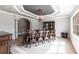 Formal dining room offers a dark wood table, coffered ceiling, and natural light at 7440 Riverside Dr, Punta Gorda, FL 33982