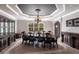 Formal dining room boasts elegant dark wood furniture, coffered ceiling and decorative light fixture at 7440 Riverside Dr, Punta Gorda, FL 33982