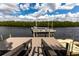Dock view with a boat lift on the water and mangroves in the background at 7440 Riverside Dr, Punta Gorda, FL 33982