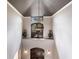 Elegant foyer features a soaring ceiling, decorative chandelier, and arched double-door entry at 7440 Riverside Dr, Punta Gorda, FL 33982
