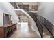 Elegant foyer with decorative staircase, neutral colors and travertine flooring at 7440 Riverside Dr, Punta Gorda, FL 33982