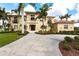 Attractive home with a circular driveway and mature landscaping at 7440 Riverside Dr, Punta Gorda, FL 33982