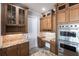 A beautifully designed kitchen with wooden cabinetry, granite countertops, and stainless steel appliances creates a modern space at 7440 Riverside Dr, Punta Gorda, FL 33982